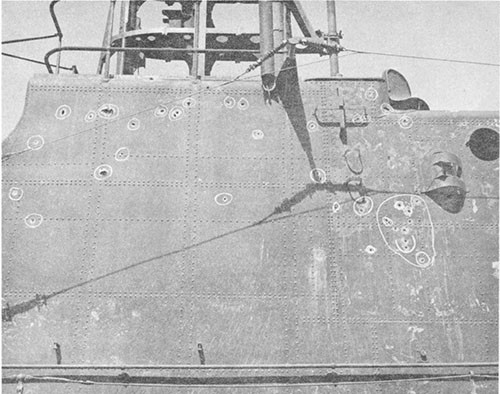 Photo 13-4: GROWLER (SS215). 13mm machine gun projectile holes, bridge and conning tower fairwater, starboard side. 