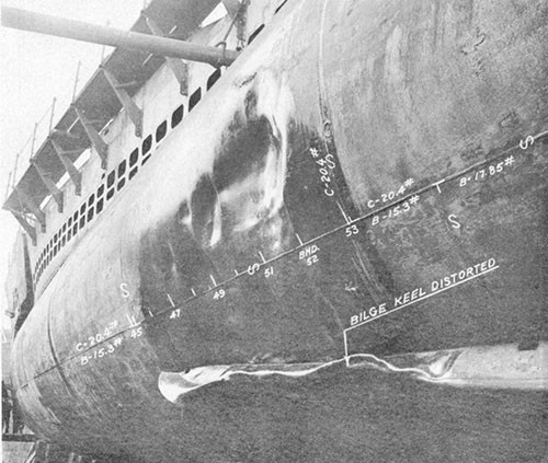 Photo 14-6: DRAGONET (SS293). View showing damage "D" in way MBT Nos. 2B and 2D. Although considerably deformed, the outer shell plating above the bilge keel was not ruptured.