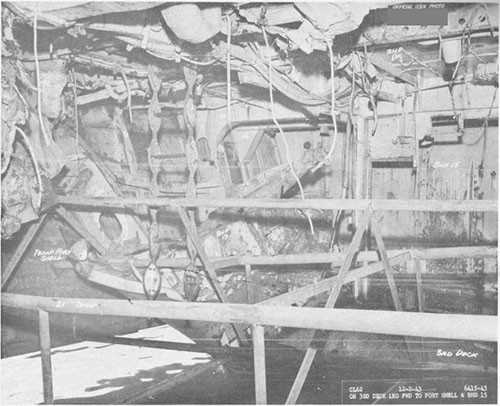 Photo 15: Torpedo damage, third deck level. Looking forward to port showing temporary pipe stringers.