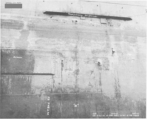 Photo 16: Torpedo damage, starboard side, snowing fragment holes in shell.