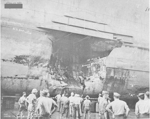 Photo 10: Torpedo damage, port side. Note temporary patch at top of hole.