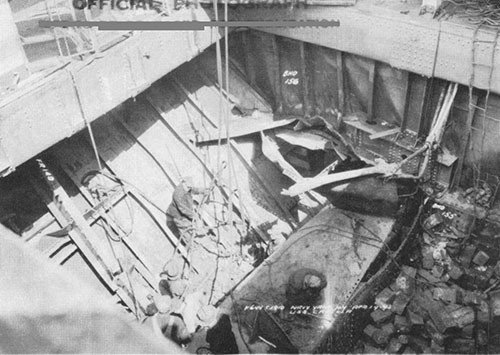 Photo 7: Damage inside No. 5 cargo space, looking aft and to starboard. Note damage to shaft alley plating, bulkhead 155 and bulkhead 156. (U.S.S. CAPELLA).