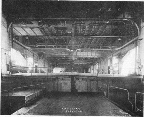 Photo E-10: First hit. View forward across No. 3 elevator pit showing bulge in main deck.