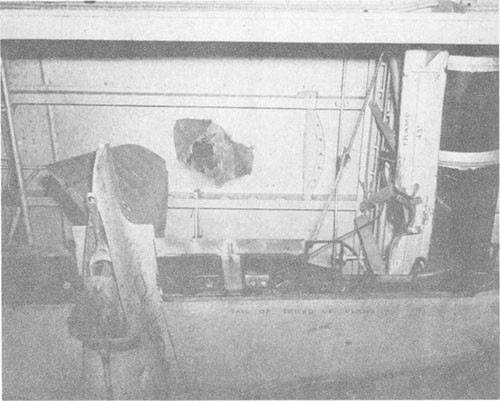 Photo F-5: Second hit. View from hangar deck showing bomb entry hole in flight deck and point of impact on transverse bent at frame 43.