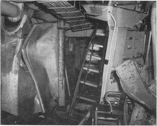 Photo F-9: Second hit. Blast effect in A-306-L, starboard side looking aft. Stanchion in center is at frame 50.