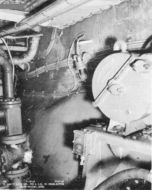 Photo F-24: Second near-miss. Deflected inner bottom plating in A-9-E, looking forward on starboard side.