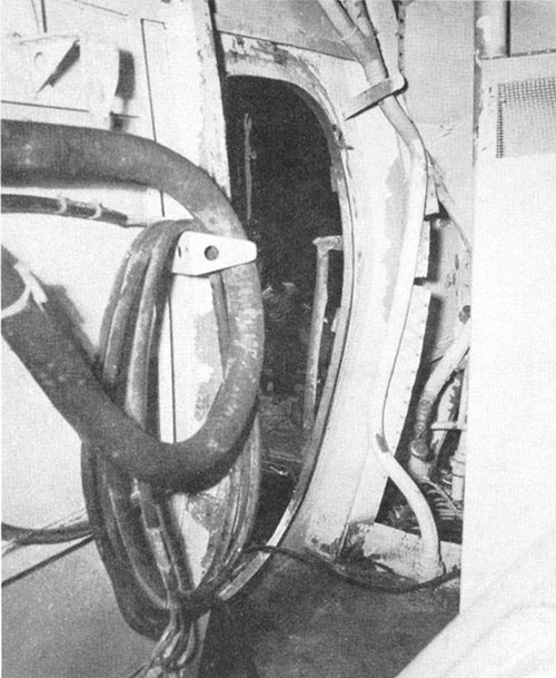 Photo J-7: Frame of quick-acting, watertight door 1-26-1 between A-104-1L and No. 1 elevator trunk. Door was blown out of frame.