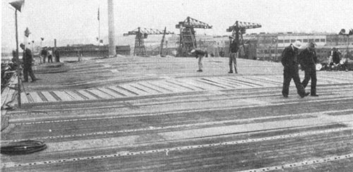 Photo J-8: View of flight deck looking forward from frame 75 showing deformation of deck.