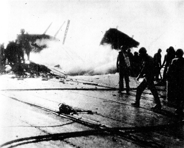 Photo 2: 30 October Action. Flight deck looking starboard and aft, showing damage at frames 125-128.