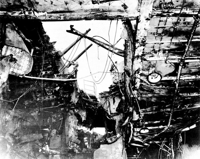Photo 3: 30 October Action. View taken from hangar looking to starboard and up. Note damage to bomb elevator trunk and sprinkler equipment.