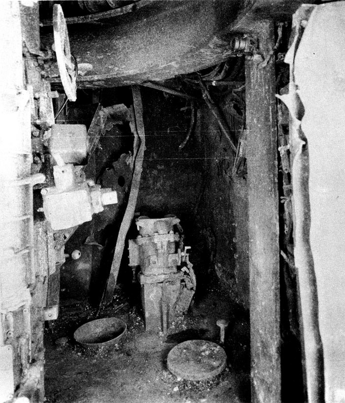 Photo 39: 19 March Action. Upper handling room No. 7 5-inch twin mount, starboard side looking forward. Forward starboard hoist is intact.