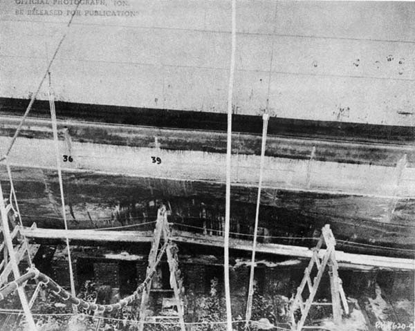 Photo No. 5: General view of damage, showing holes cut to admit Wheeler System cleaning hose.