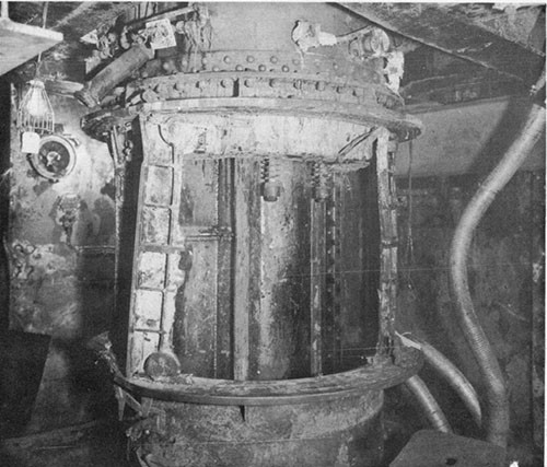 Photo 11: USS NEW ORLEANS - Damage to flame-proof doors of 8" powder hoist, lower handling room of turret II.