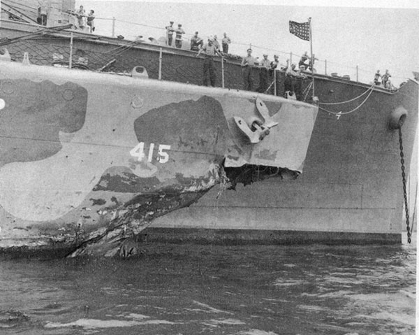 Photo 2: Damage to bow resulting from torpedo hit between frames 1-6, port. Alongside U.S.S. CURTISS, 17 September, 1942.