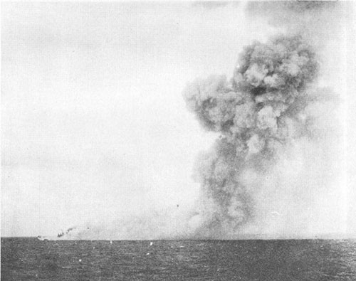 Smoke from detonation of bombs stowed in torpedo stowage. BIRMINGHAM visible at left edge of smoke.