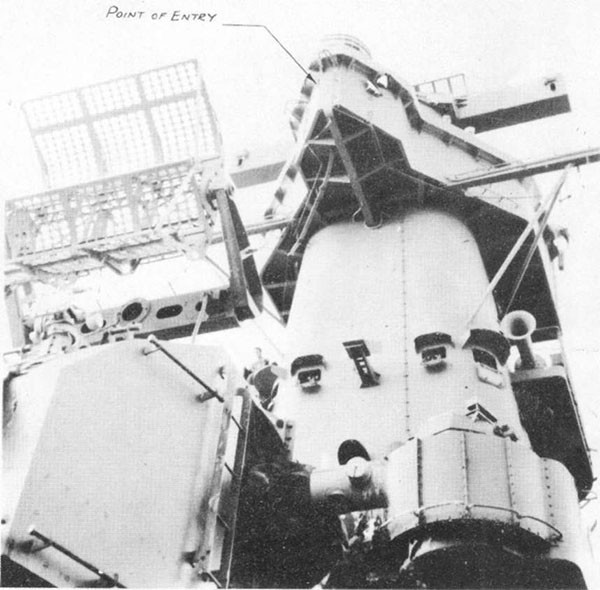 Photo 12: Exit holes of hit No. 9 on port side of wind and spray shield around air defense forward. Entry hole on starboard side of spray shield can also be seen.