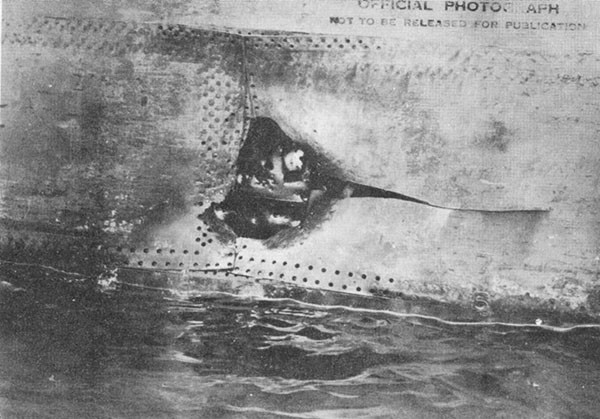 Photo 16: Hit No. 11 on starboard shell. Note fragment holes in torpedo bulkhead No. 2.