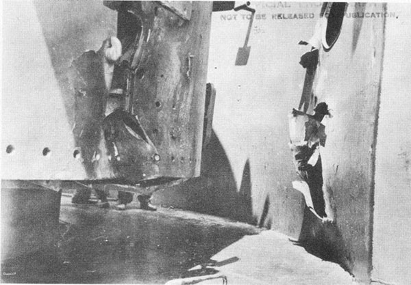 Photo 27: Hit No. 17. Port longitudinal structural bulkhead. Note damage to 5-inch mount No. 2 which stopped this projectile.
