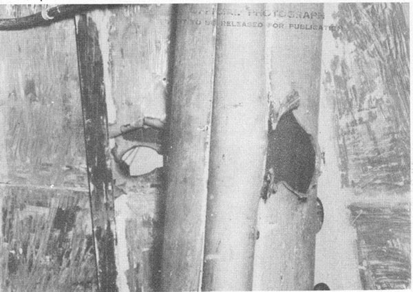 Photo 29: Hit No. 22. Hole in starboard structural bulkhead and foremast housing in battle dressing room.