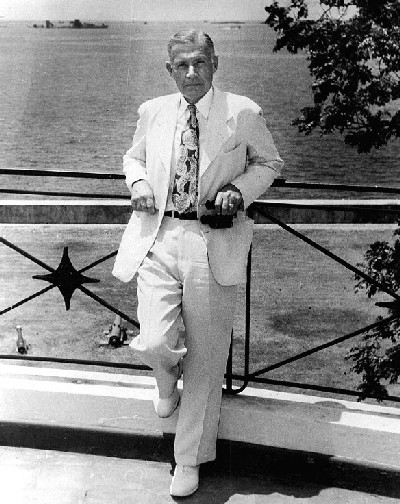 Admiral Raymond A. Spruance, USN (Retired). On the balcony of the U.S. Embassy, Manila, while serving as U.S. Ambassador to the Philippines in 1952-55. Several Japanese ships, sunk in Manila Bay during World War II, are visible in the background....