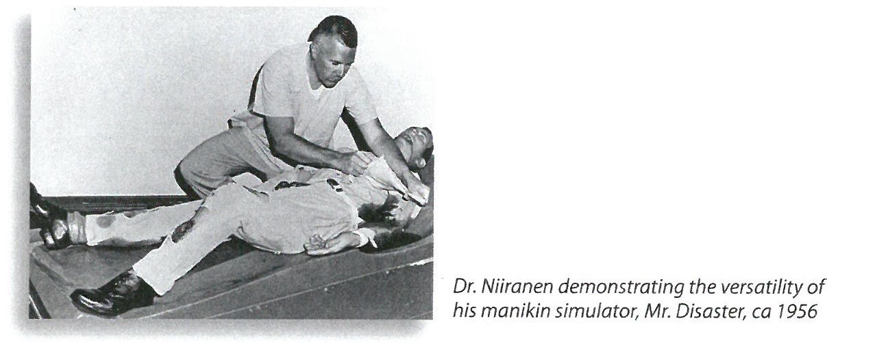 jpeg photo showing Dr. Niiranen demonstrating the versatility of his manikin simulator, Mr. Disaster, ca 1956