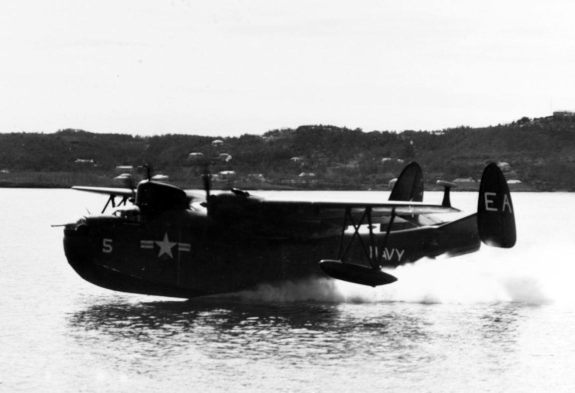 Black and white photo of a PBM-5 patrol plane just leaving the surface of the water.