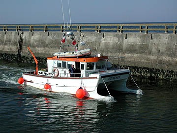 Figure 1: Survey vessel Genesis leaves the harbor at Grandcamp-Maisy, France.