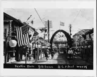 Street decorated with flags and lanterns at Benten Dori, Yokohama, during U.S. Fleet Week in October 1908.