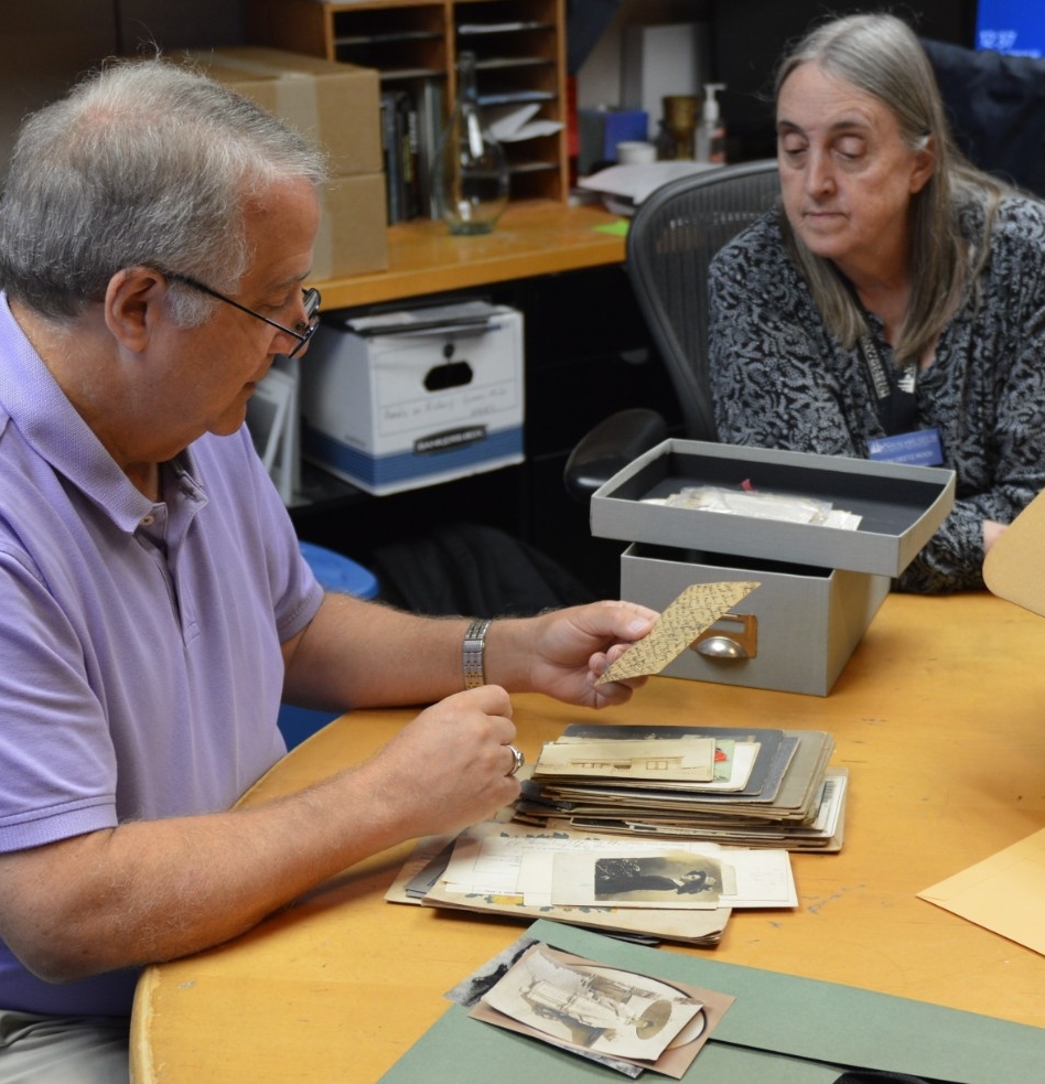 A photo depicting artifacts being unpacked and reviewed by the curatorial staff at the Hampton Roads Naval Museum. 