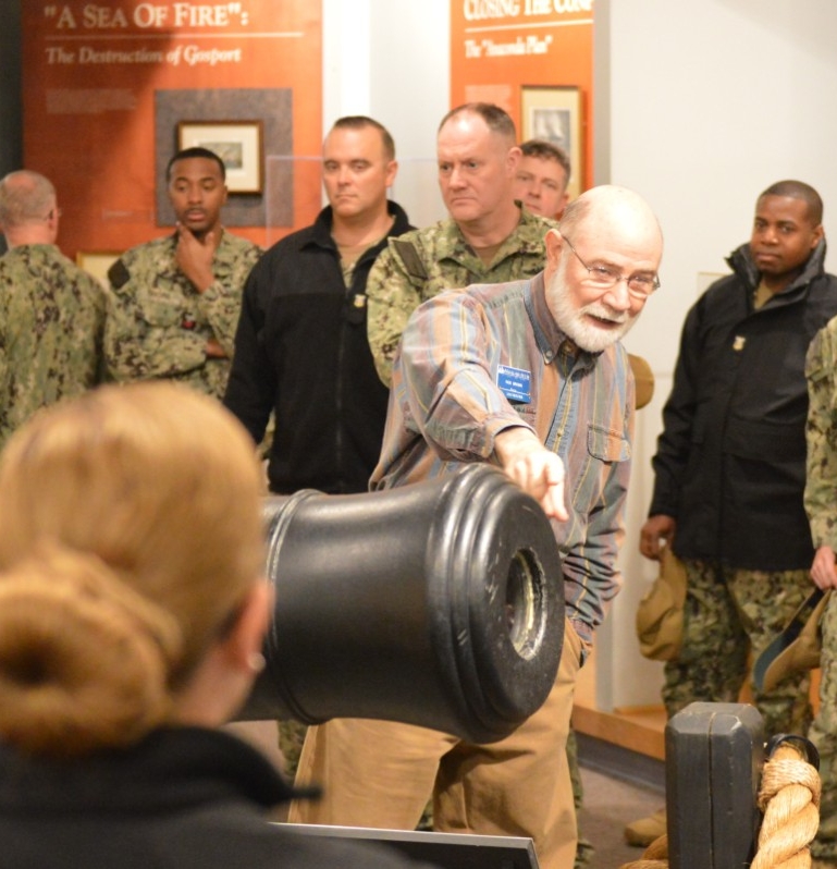 Rick Brown, a volunteer docent at the Hampton Roads Naval Museum (HRNM), provides a guided tour through the museum’s gallery to Sailors assigned to Naval Medical Forces Atlantic (NMFL).