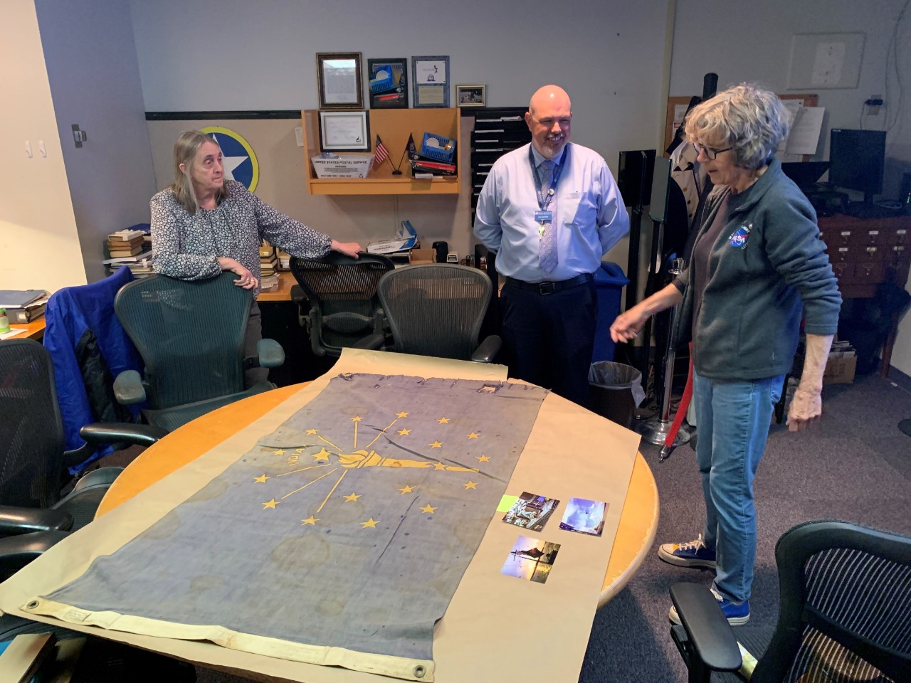 A photo depicting the an artifact being reviewed by curatorial staff at the Hampton Roads Naval Museum. 