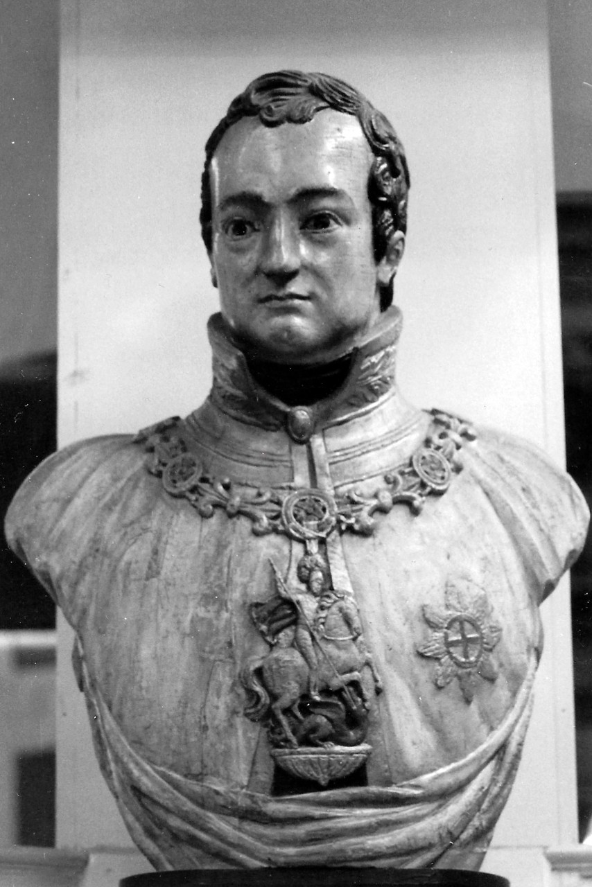 NMUSN-142: Wooden figurehead. This wooden figurehead from the early 19th century bears a striking resemblance to the Prince Regent, who later became King George IV of England. The two decorations on his chest are the Order of St. George and the S...