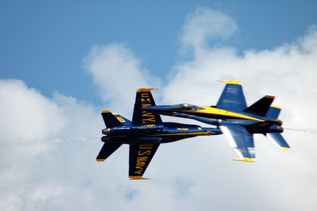 040516-N-9909C-001:  Blue Angels Maneuvers:  Scissors-Cross.  F/A-18 Hornet.   The lead and opposing solo pilots assigned to the U.S. Navy's flight demonstration team, the "Blue Angels," perform a close scissors-cross maneuver in front of the crowds at the 2004 Joint Service Open House, May 16, 2004. The "Blue Angels" fly the F/A-18A Hornet as they perform approximately 30 maneuvers during the aerial demonstration, which runs approximately an hour and 15 minutes. The Open House, held on May 14-16th at Andrews Air Force Base, Maryland., showcased civilian and military aircraft from the Nation's armed forces. Photographed by U.S. Navy photo by Lieutenant Commander Jane Campbell.   Official U.S. Navy Photograph.  