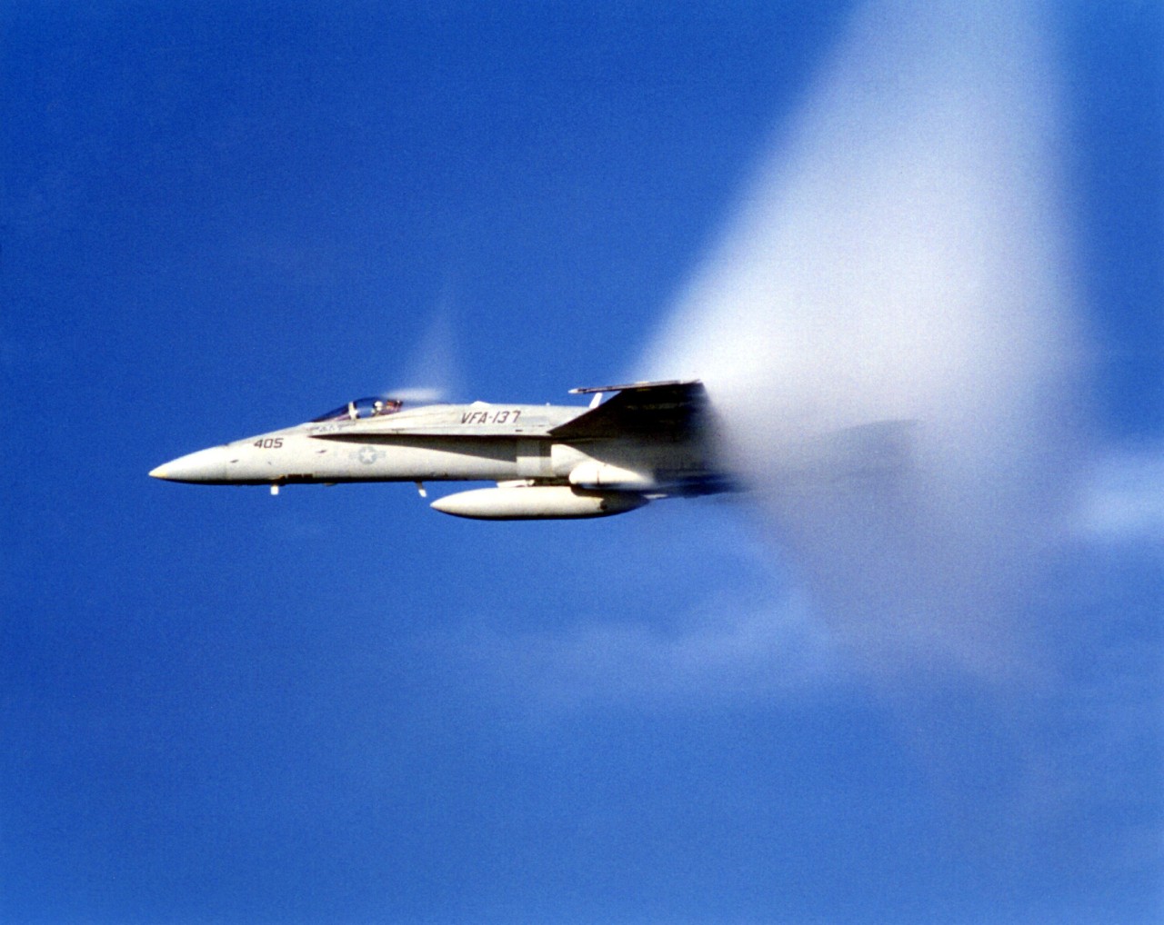330-CFD-DN-SD-90-05858:   F/A-18 Hornet, January 1990.   An F/A-18 Hornet from Strike Fighter Squadron 137 (VFA-137) files faster than sound, creating a sonic boom and a visual mist during an exercise off the coast of San Diego, California, January 1, 1990.  Official U.S. Navy Photograph, now in the collections of the National Archives.   