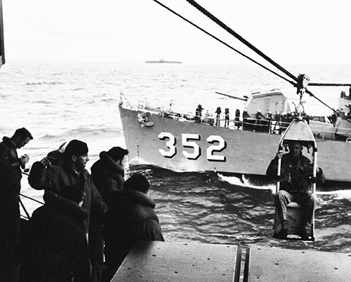 330-PS-7151 (USN 654922):  AD1 R. K. Drennan, crew member of the AD-5W recently shot down by Communist gunfire and ditched near the Tachen Islands, is transferred by highline from USS Naifeh (DE 352) to USS Wasp (CVA 18), February 16, 1955.  Official U.S. Navy photograph, now in the collections of the National Archives.  