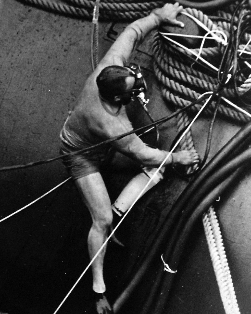 428-GX- USN 118933:  Senior Chief Boatswain’s Mate and Master Diver Carl M. Brashear, April 1971.  Brashear checks line on the deck of USS Hunley (AS-31).    Brashear wears an artificial partial left leg as the result of an accident which occurred in the line of duty.    Photographed by PHC A.J. Walker, April 22, 1971.  Official U.S. Navy Photograph, now in the collections of the National Archives.  