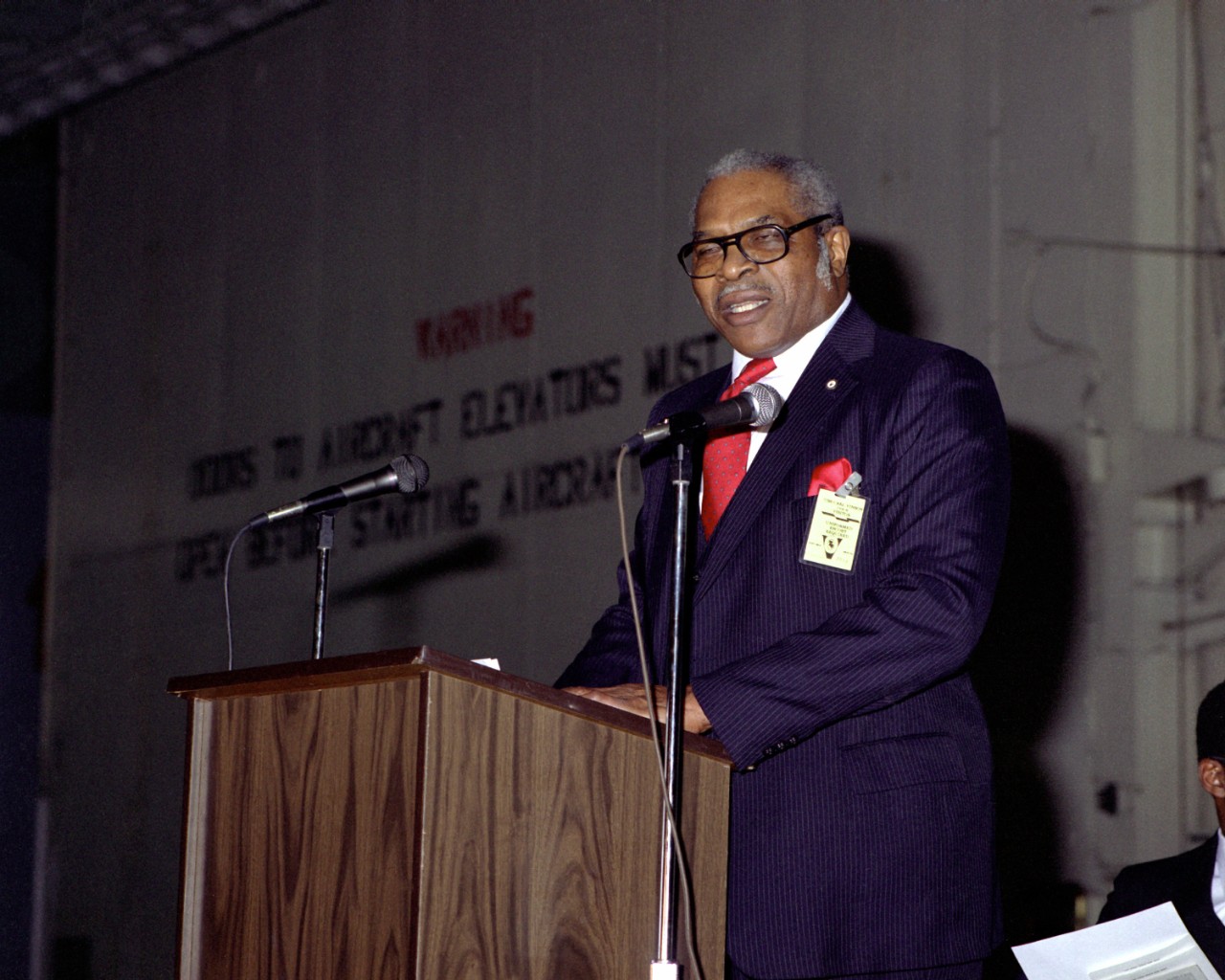 330-CFD-DN-SC-86-10323:  Black History Week, February 1986.   Jesse Arbor of the Golden Thirteen addresses crew members and guests during a Black History Week celebration onboard USS Carl Vinson (CVN-70).   Photographed by PH2 C.F. Laws, February 20, 1986.   Official U.S. Navy Photograph, now in the collections of the National Archives.