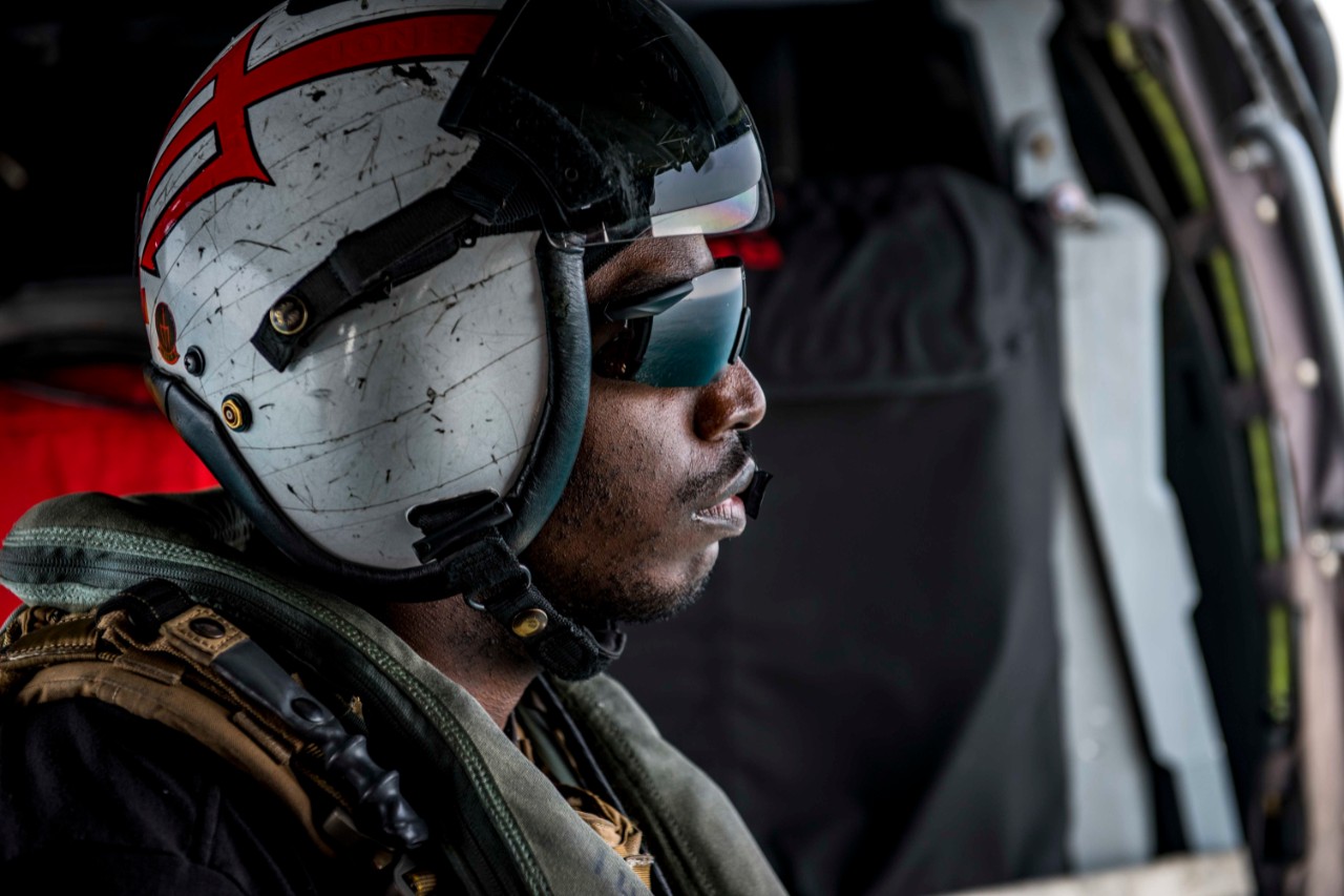 180512-N-JU894-0081:   Hospital Corpsman Second Class Ryan Jones, 2018.    Hospital Corpsman 2nd Class Ryan Jones, from Fayetteville, North Carolina, looks out over the water from an MH-60S Sea Hawk assigned to Helicopter Sea Combat Squadron (HSC) 9. The squadron is embarked aboard the aircraft carrier USS George H.W. Bush (CVN-77) and underway in the Atlantic Ocean conducting carrier air wing exercises with the French navy to strengthen partnerships and deepen interoperability between the two nations' naval forces.  Photographed on May 12, 2018 by Mass Communications Specialist Third class Brooke Macchietto.   Official U.S. Navy photograph, now in the collections of the National Archives.  