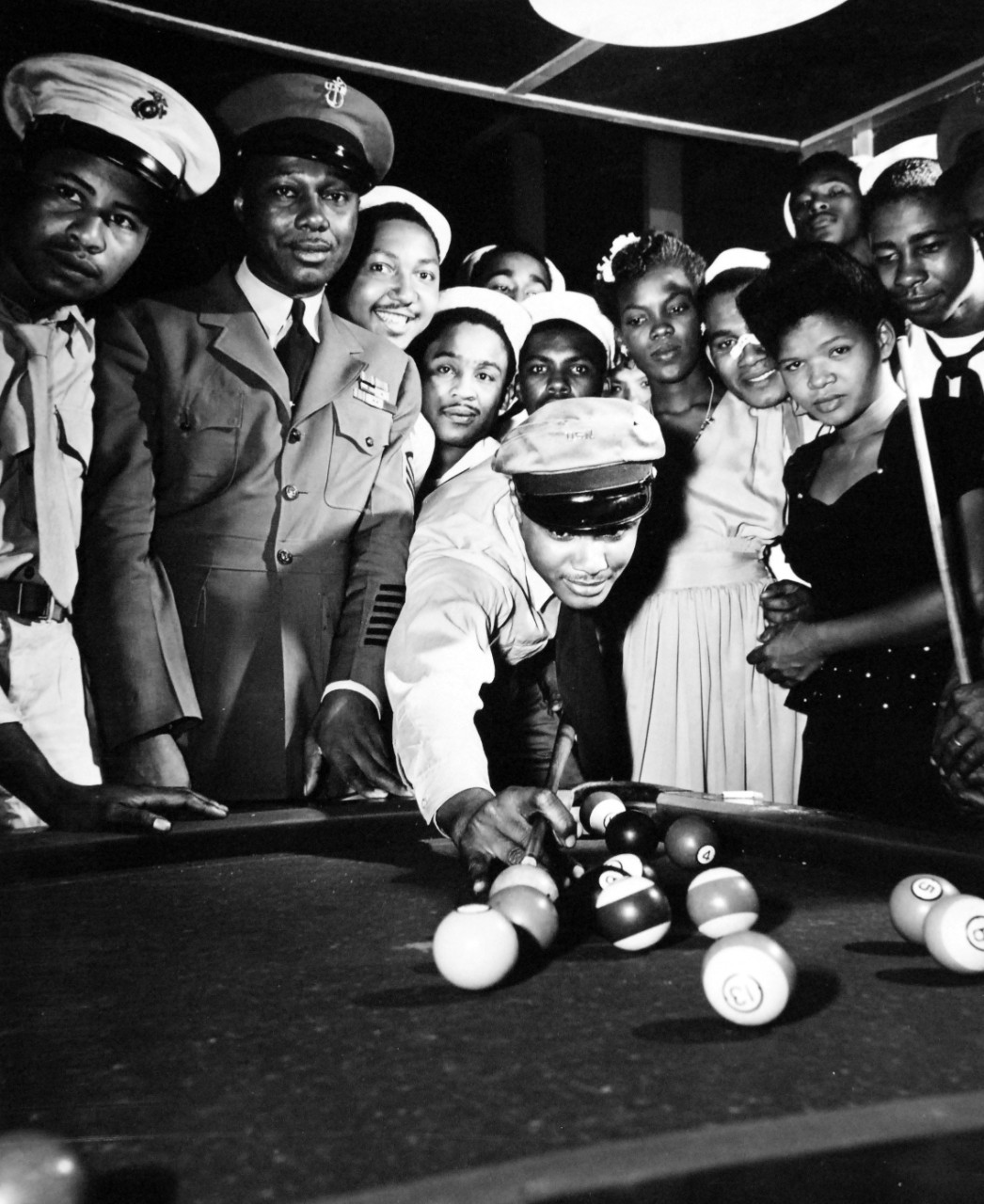 80-G-702692:  USO, Port of Spain, Trinidad, May 1946.  An 8th Fleet Steward’s Mate takes his cue at game of pool at the USO in Port of Spain, Trinidad, May 24, 1946. Official U.S. Navy Photograph, now in the collections of the National Archives.  