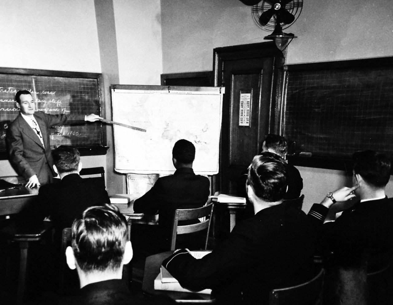 80-G-707014:   Midshipman Wesley Brown, June 1949.   U.S. Naval Academy, Annapolis, Maryland.  Shown:  Lecture in Department of English, History and Government.  Course in “Elements of National Power”, released June 3, 1949.  In this group is Midshipman Wesley Brown.   Note, Brown was the first African-American to graduate from the U.S. Naval Academy and served as a Civil Engineer, retiring in June 1969 with the rank of Lieutenant Commander.   Brown died on May 12, 2012.   U.S. Navy Photograph, now in the collections of the National Archives.  Note, the image is curved.  
