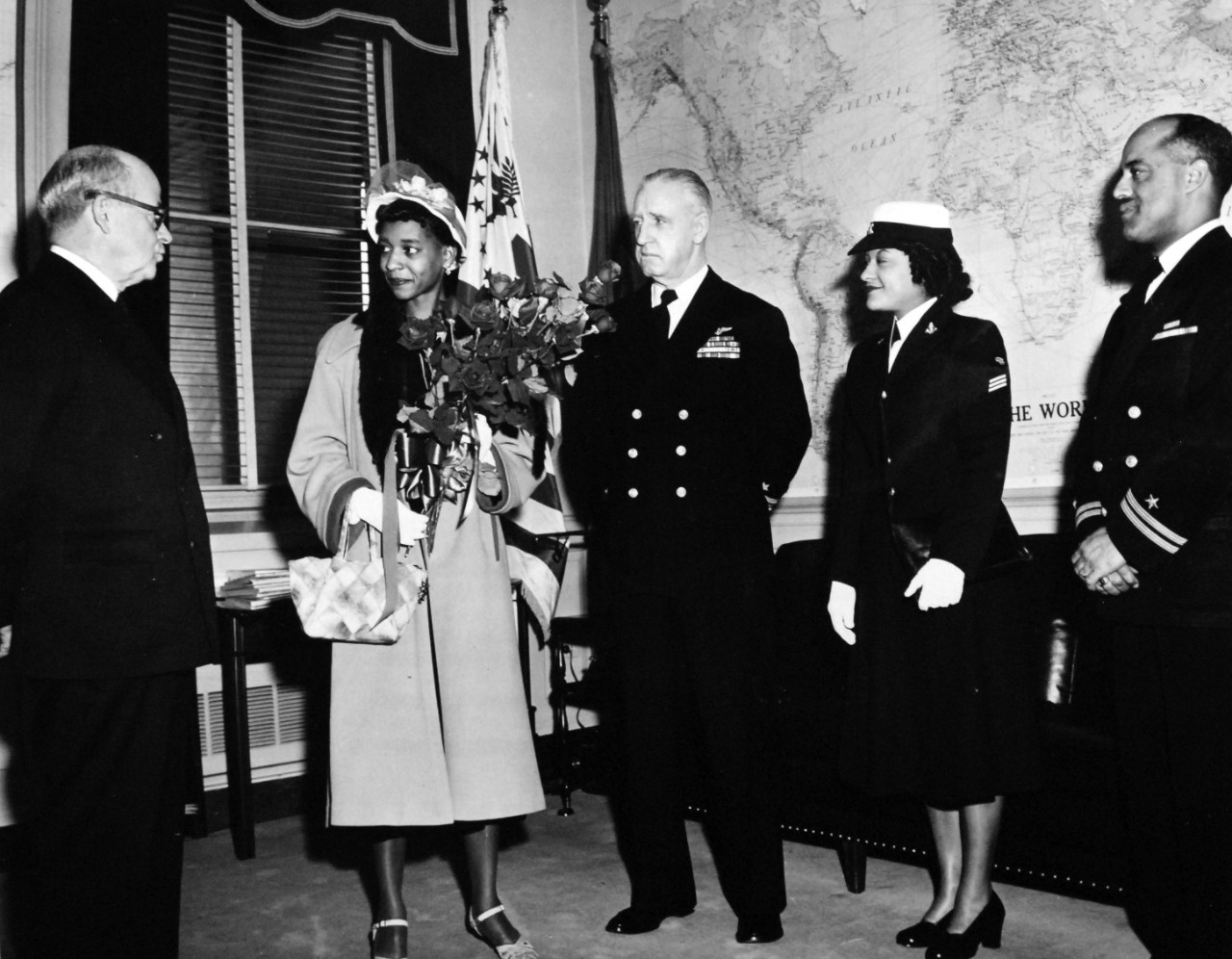 USN 708206:   Navy Aviator Receives Medal of Honor, April 1951.   In his office at the Pentagon, Secretary of the Navy Francis P. Matthews, (left), greeted Mrs. Daisy P. Brown, (second from left), widow of Ensign Jesse Leroy Brown, the first African American Naval Officer to lose his life in any United States war.   Left to right, are Secretary Matthews, Mrs. Brown, Rear Admiral Robert F. Hickey, USN, Chief of Information, Seaman First Class Clara Carroll, USN, and Lieutenant Dennis D. Nelson, USN.   For the attempted rescue of Ensign Brown, whose plane struck by anti-aircraft fire and trailing smoke, was forced down behind enemy lines in the Chosin Reservoir area of Korea on December 4, 1950.  Lieutenant Junior Grade Thomas J. Hudner, Jr., USN, received the Medal of Honor from President Harry S. Truman at a ceremony at the White House.   Photograph released April 13, 1951.  Official U.S. Navy Photograph, now in the collections of the National Archives.  