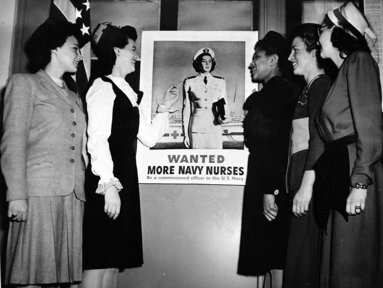 208-NP-8ZZ-2:   New Ensigns, March 1945.   These new Ensigns, the first commissioned in New York under the Navy’s new speed-up nurse recruiting system, were sworn in on March 8, 1945, at the Office of Naval Officer Procurement.  Included was the first African-American nurse commissioned by the U.S. Navy.  The five, left to right:   Marion Helen Bendix; Barbara Joan Zeigler; Phyllis Mae Daley; Adele Lee Bruce; and Jane Agnes Delanger.  In order to speed commissioning, the system was instituted a month ago to have registered nurses make applications through the New York office rather than direct inquiries to the Surgeon General’s office in Washington.   Official U.S. Navy photograph, now in the collections of the National Archives.