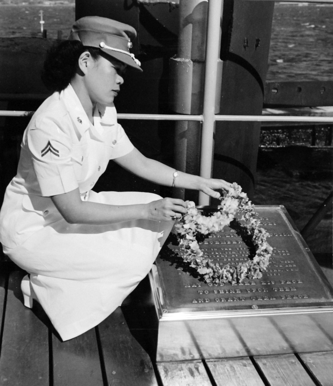 80-G-436654:  Corporal Evangeline Lyau, USMC, 1951.   Lyau places wreath on plaque aboard the remains of USS Arizona (BB-39), commemorating 10th Anniversary of Attack on Pearl Harbor, December 7, 1951.  Official U.S. Navy Photograph, now in the collections of the National Archives. 