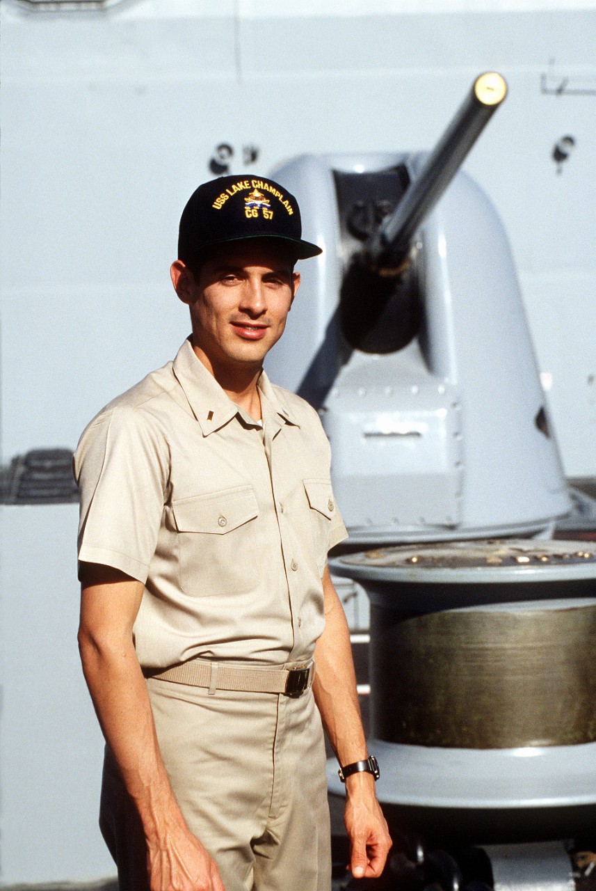 330-CFD-DN-ST-94-02150:   Ensign Jorge Parra, 1993.    Parra, Hispanic communications officer of USS Lake Champlain (CG-57) taken on the forward deck of the ship with the Mark 45 inch/54 caliber gun in the background.  Photographed by PH1 M.C. Farrington.  Official U.S. Navy photograph, now in the collections of the National Archives.  