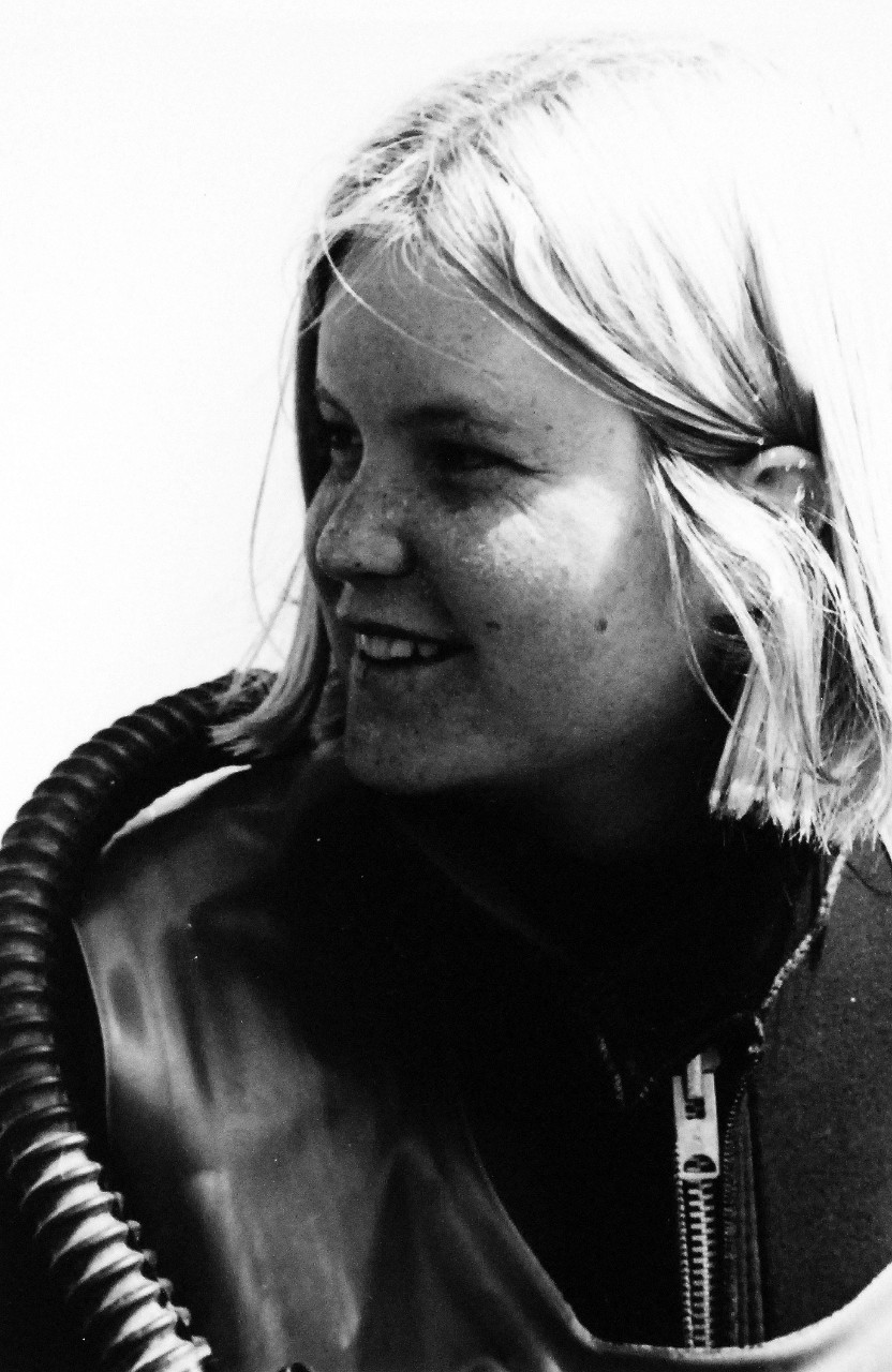428-GX-USN-1158747: Personnelman Seaman Diver, Nancy (Kati) Garner, March 1974. She sits on the deck of a personnel landing craft, LCPL, prior to a dive at San Diego, California.  She is the first female Navy diver and is assigned to the Fleet Aviation Specialized Operational Training Group, Pacific.   Photographed by PHC Warren Grass, 1974.  Official U.S. Navy Photograph, now in the collections of the National Archives.  
