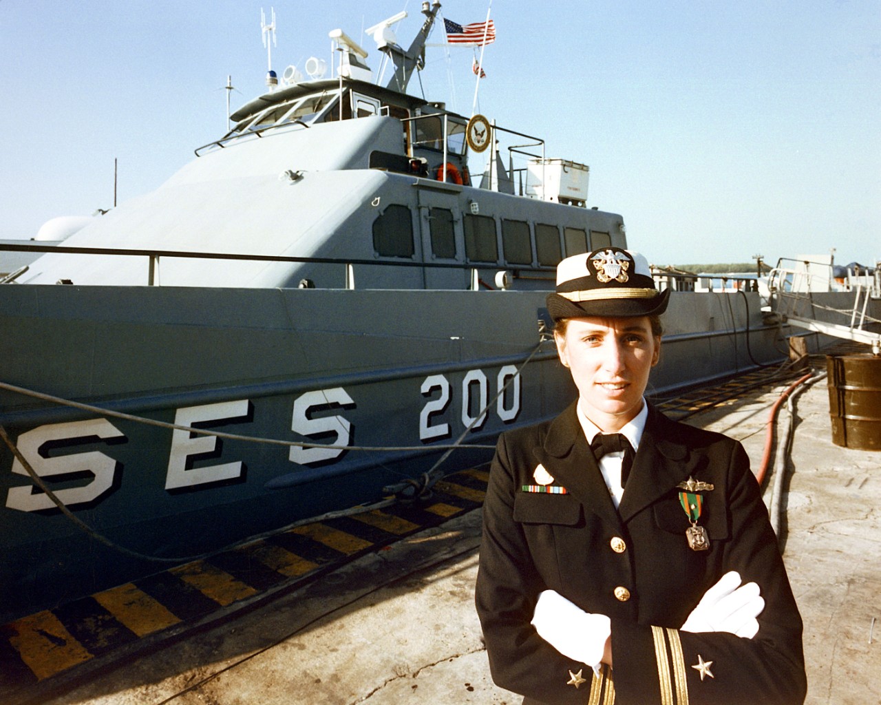 330-CFD-DN-SC-86-01059:   Lieutenant Maureen Farren, 1985.   Farren was Officer in Charge of surface effect ship, SES 200.   Photographed at Key West, Florida, November 21, 1985.   She is wearing the Navy Achievement Medal.   Farren would later be one of the first female commanding officers of a combatant U.S. Navy ship.    Official U.S. Navy photograph, now in the collections of the National Archives.  