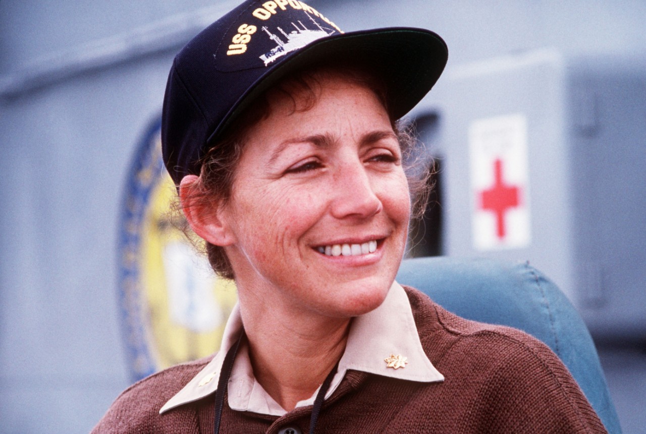330-CFD-DN-ST-91-06050:  Lieutenant Commander Darlene M. Iskra, 1990.   Iskra smiles for the camera shortly after her appointment as commanding officer of the salvage ship USS Opportune (ARS-41). Iskra's appointment represents the first time that a woman has been assigned to command a U.S. Navy ship.  JO1 Mike O'Shaughnessy, USN.  Official U.S. Navy photograph, now in the collections of the National Archives.  