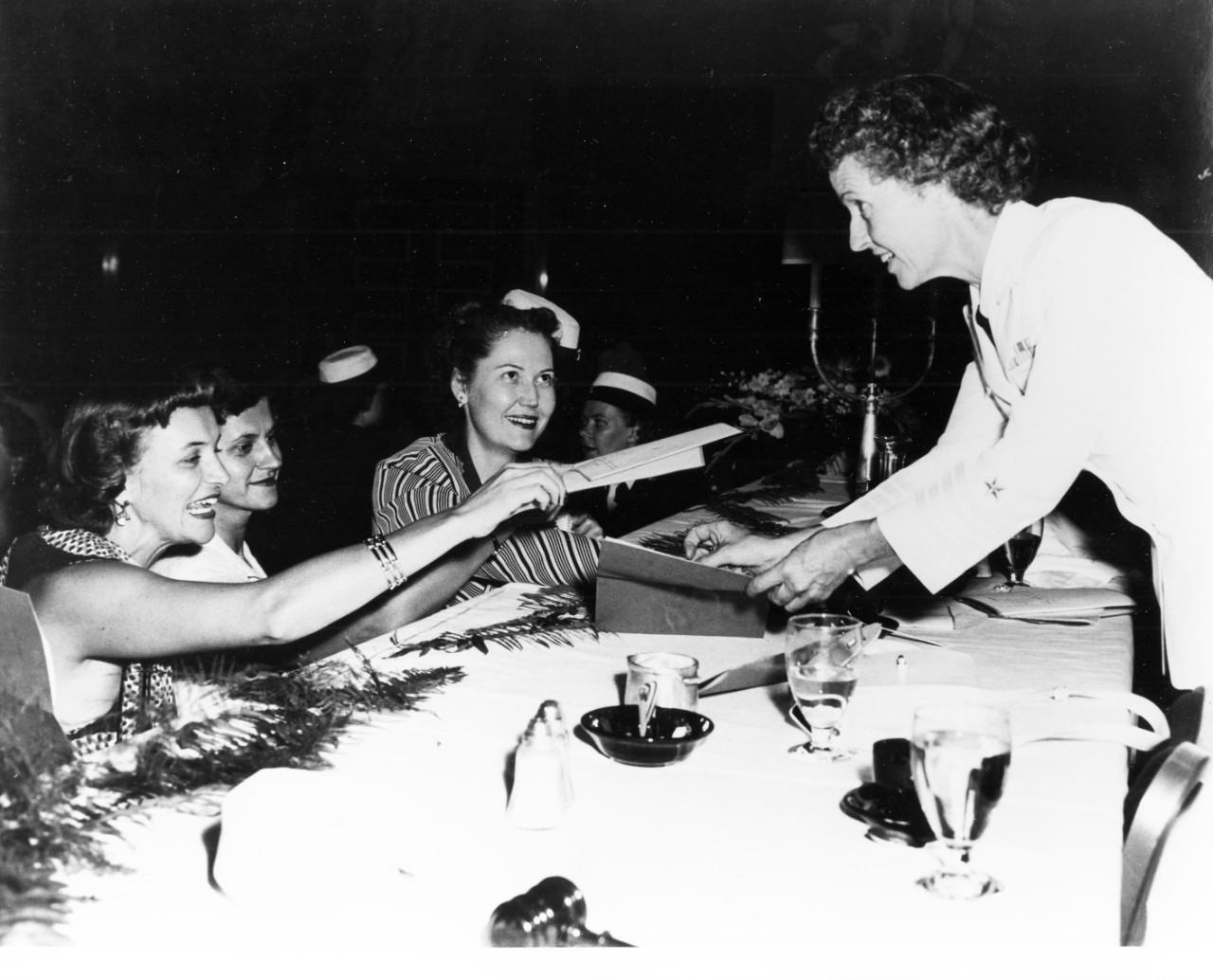 80-G-708663:  Tenth Anniversary of the WAVES, July 1952.  Captain Joy Bright Hancock, Director of the WAVES, signs autographs at a 10th Anniversary reunion of WAVES held at Hotel Statler, Washington, D.C.   Photograph dated July 21, 1951, but probably taken on that date in 1952.   Official U.S. Navy photograph, now in the collections of the National Archives. 