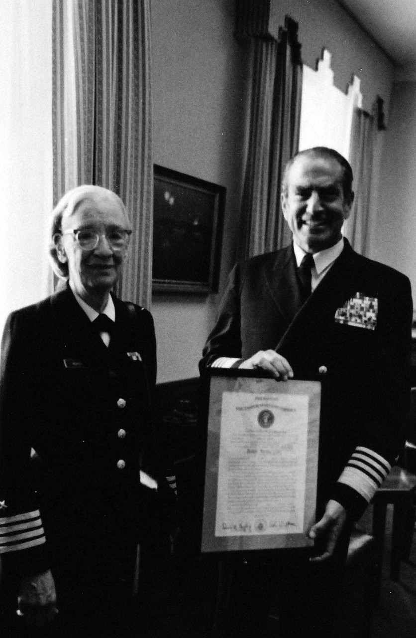 428-GX-USN 1157763:  Captain Grace Hopper, August 1973.   Pentagon, Washington.  Admiral Elmo R. Zumwalt, Jr., USN, Chief of Naval Operations, presents a certification of promotion to the rank of Captain to Commander Grace Hopper, Head of Programming Language Section of the Naval Information Systems Division (OP 91).  Captain Hopper was the first Naval Reserve woman to be called back to active duty.    Photographed by Bill Mason, August 13, 1973.  Photographed from small reference card.  Official U.S. Navy Photograph, now in the collections of the National Archives.  