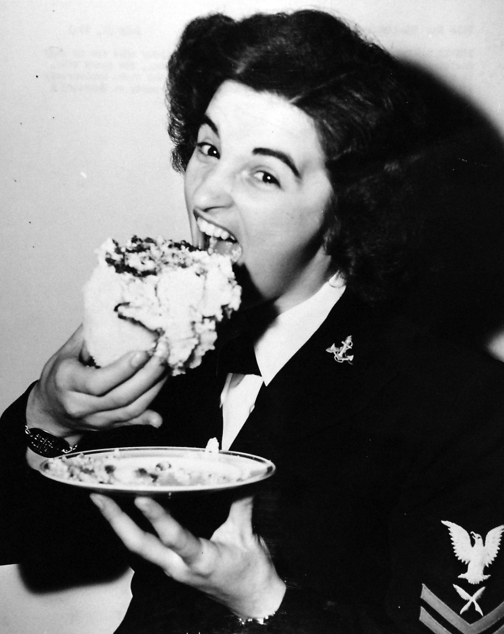 80-G-42495:  Celebration of the WAVES’ First Anniversary, July 1943.  Yeoman Second Class Dorothy Barbara opens wide while eating her piece of birthday cake at the party held in Quarters A, Washington Navy Yard, Washington, D.C.  Photographed:  July 30, 1943.  Official U.S. Navy photograph, now in the collections of the National Archives. 